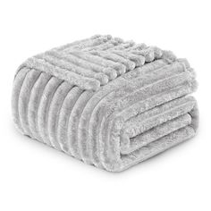 a pile of white towels stacked on top of each other in front of a white background