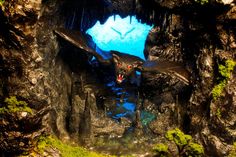 a bat is flying out of a cave