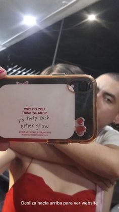 a woman in a red dress holding up a cell phone with a message on it