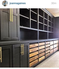 black cabinets with gold handles and drawers in an office building or showroom are lined up against the wall