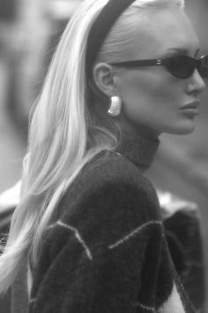 a woman with long blonde hair wearing sunglasses