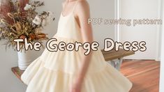 a woman in a white dress standing on a wooden bench with the words, the george dress