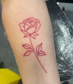 a red rose tattoo on the arm