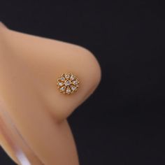 a close up of a ring on a mannequin's torso with an object in the background