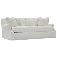 a white couch with several pillows on it's back and one arm facing the camera