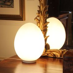 a lamp sitting on top of a wooden table next to a mirror