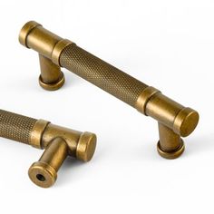 two brass colored handles and knobs on a white background with clipping for text