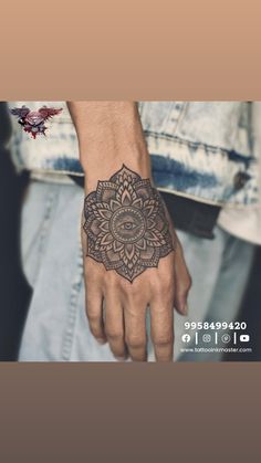 a man's hand with a tattoo on it and a flower in the middle