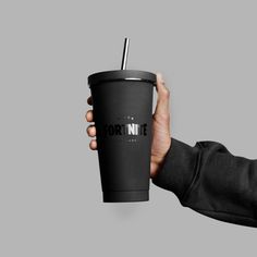 a hand holding a black coffee cup with a straw in it and the words torntite on it