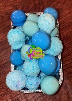 blue and white cake balls in a basket on a table with the words grandma crazy creations