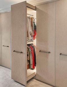 an open closet with clothes on hangers