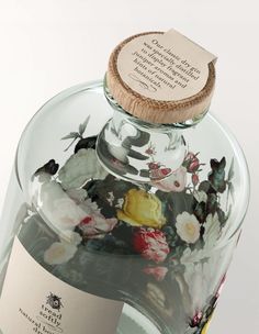 a bottle filled with lots of different types of flowers