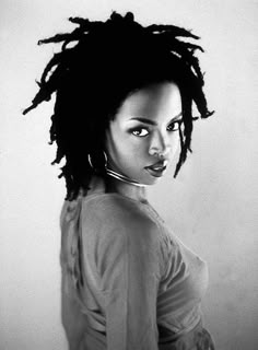 a black and white photo of a woman with dreadlocks