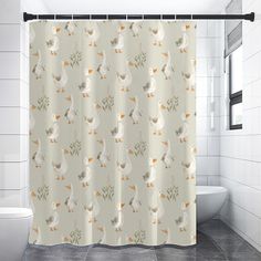 a shower curtain with ducks and leaves on it