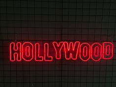 a red neon sign that reads hollywood