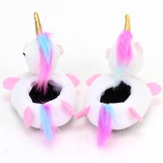 two unicorn slippers with pink, blue and yellow hair on them are shown in front of a white background