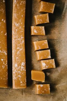 several pieces of cheese sitting on top of a piece of wax paper next to each other