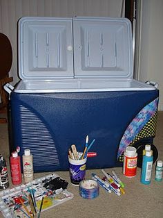 the cooler is full of supplies for painting