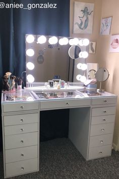 a vanity with lights on it in front of a mirror