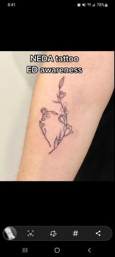 a small tattoo on the arm with flowers and leaves in it's middle section