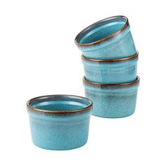 four blue bowls stacked on top of each other in front of a white background with gold rims