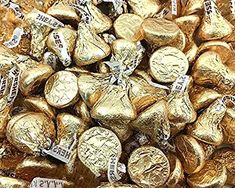 a pile of gold foiled chocolate hearts