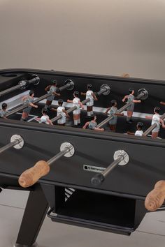 a foosball table with many people standing around it