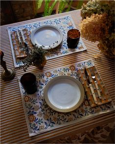 a table set for two with place settings