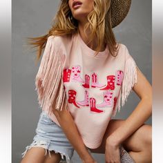 Crew Neckline Fringe Sleeves Western Boot Printed Graphic No Closures Not Lined Length Is 28” Spring Short Sleeve Tops With Fringe, Spring Crew Neck Top With Fringe, Spring Fringe Crew Neck Tops, Spring Fringe Tops, Pink Fringed Top For Spring, Pink Fringe Top For Spring, Spring Pink Fringed Tops, Fringe T Shirt, Fringe Sleeves