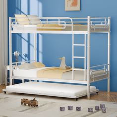 a white bunk bed sitting on top of a hard wood floor next to a blue wall