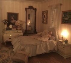 a doll is laying on a bed in a room with white furniture and wallpaper