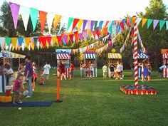 an outdoor carnival with colorful flags and people