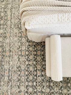 a white couch sitting on top of a rug