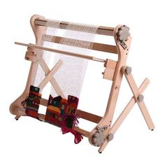 a wooden weaving machine with two rows of yarn on the front and sides, holding several different types of items