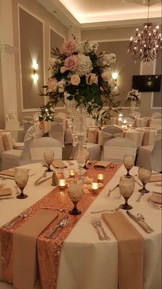 the tables are set with silverware and candles for an elegant wedding reception at the hotel