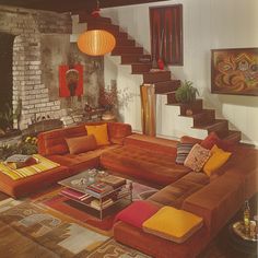 a living room filled with lots of furniture next to a stair case and fire place