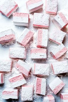 pink and white marshmallows on a baking sheet