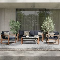 an outdoor living room with furniture and plants