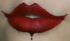 a woman's lips with blood dripping from the top and bottom lip on her face