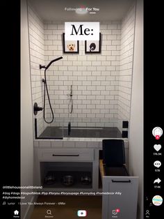 the bathroom is decorated with white subway tiles and black accessories, including a shower head