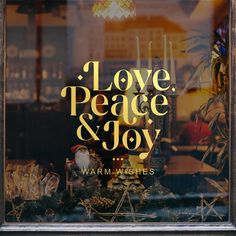 i love peace and joy window display with candles, figurines and other decorations