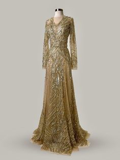 Immerse yourself in the splendor of this Anna Augusta Evening Maxi Dress, a masterpiece in a shimmering gold color. Brand new with tags, this size 8 gown features a breathtaking array of hand-sewn sequins and beads that cascade down its length, creating a dazzling display of light and texture. The dress boasts a flattering, intricately detailed design with long sleeves and a subtle train, ensuring every entrance is as grand as the occasions it graces. Perfect for high-profile events, this gown embodies luxury and elegance. Brand New with Tags: Ensures top quality and untouched elegance. Radiant Gold Sequins and Beads: Offers a stunning, eye-catching sparkle. Elegant Long Sleeves: Adds a touch of sophistication and style. Flawlessly Detailed: Exquisite craftsmanship visible in every aspect. Luxury Shimmer Maxi Dress For Gala, Silver Dresses, Evening Maxi Dress, Detailed Design, Maxi Dress Evening, Gold Sequins, Gold Branding, Silver Dress, Dress Clothes For Women