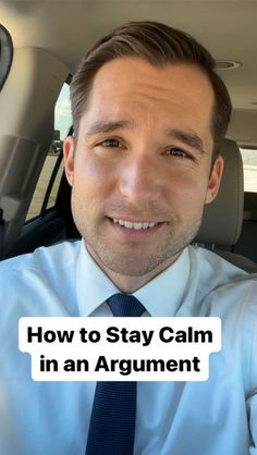 a man sitting in the back seat of a car wearing a blue shirt and tie