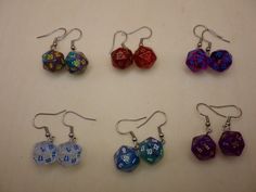 Mini D20 (Twenty-Sided) Dice Earrings Stainless Steel Hook Dangle Style - Multiple Style Options Approximately 10mm Die These are sold by the pair. Choose which style option you want to buy or buy all 6. Not our only listing for dice-crafted earrings! *Stock Photo **Due to the nature of this product colors and patterns will vary slightly from those of the photos and each other.  Warning, Choking Hazard All Measurements are Approximate. Dice Earrings, Crafted Earrings, Ruby Red, Purple Gold, The Twenties, Jewelry Earrings Dangle, Dangle Drop Earrings, Dangle Earrings, Handmade Items