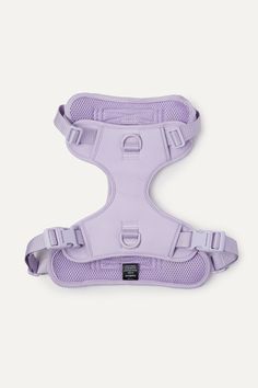 a purple dog harness on a white background