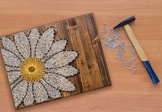 a piece of wood that has been made to look like a flower with white and yellow petals