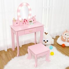 a child's pink vanity table with stool and mirror