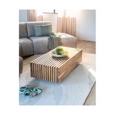 a living room scene with focus on the coffee table and shoes laying on the floor