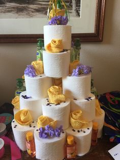 a cake made out of toilet paper with yellow and purple decorations