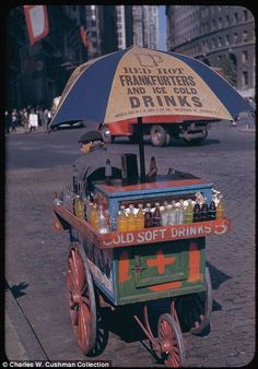 an old fashioned cart with drinks on the street